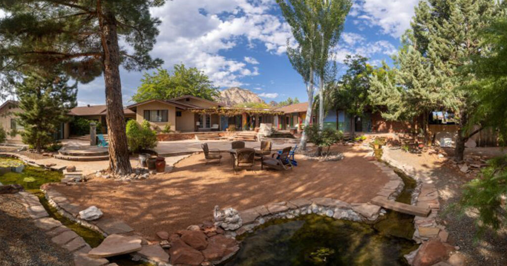 Courtyard and pond garden at the ATMC residence in Sedona, with red rocks in the distance