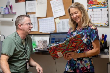 Two people at Alternative to Meds Center going over a plan together